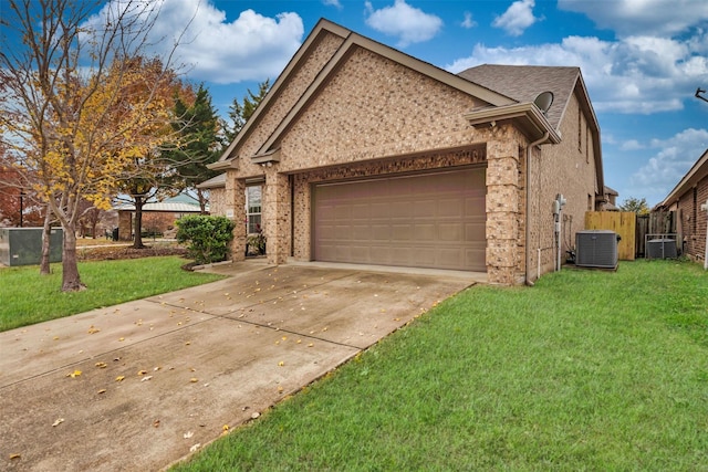 view of side of property featuring brick siding, a yard, concrete driveway, central AC, and a garage