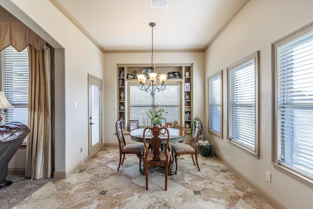 dining room featuring built in features, ornamental molding, baseboards, and an inviting chandelier