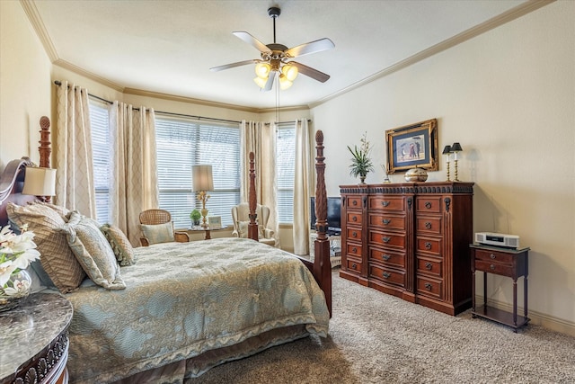 carpeted bedroom with baseboards, a ceiling fan, and crown molding