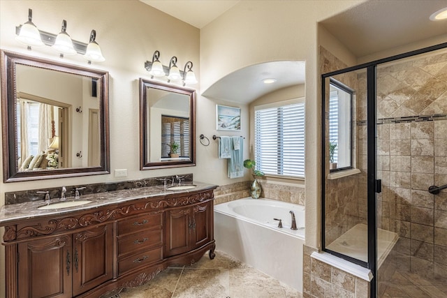 full bathroom with double vanity, a stall shower, a sink, and a bath