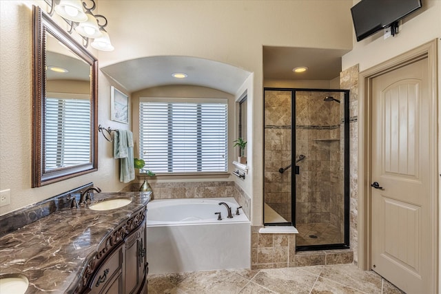 full bathroom with a bath, a healthy amount of sunlight, a shower stall, and a sink