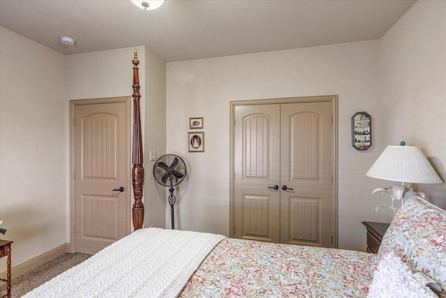 carpeted bedroom with baseboards and a closet