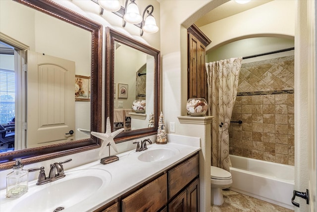 full bathroom featuring shower / bath combo with shower curtain, a sink, toilet, and double vanity