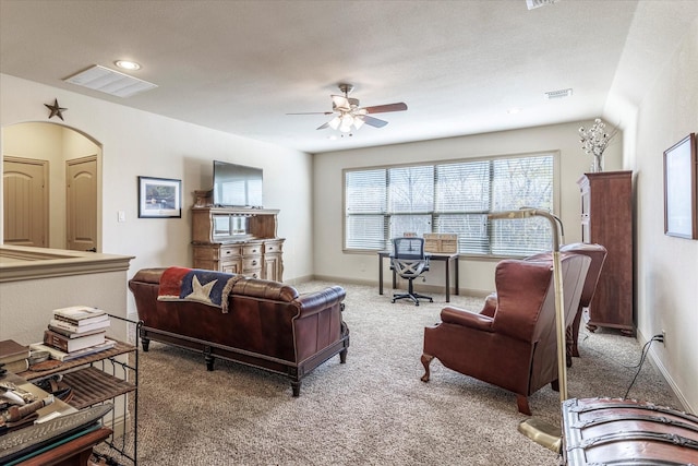 carpeted living area featuring visible vents, ceiling fan, and baseboards