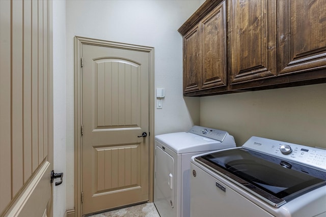 laundry room featuring cabinet space and washing machine and clothes dryer