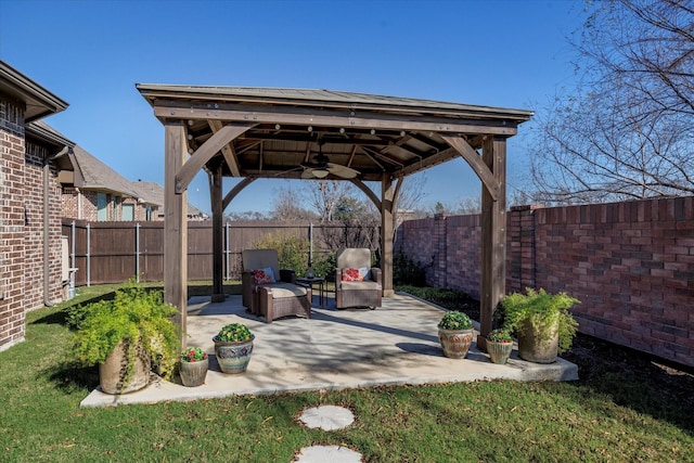 view of patio / terrace featuring a gazebo, a fenced backyard, and a ceiling fan