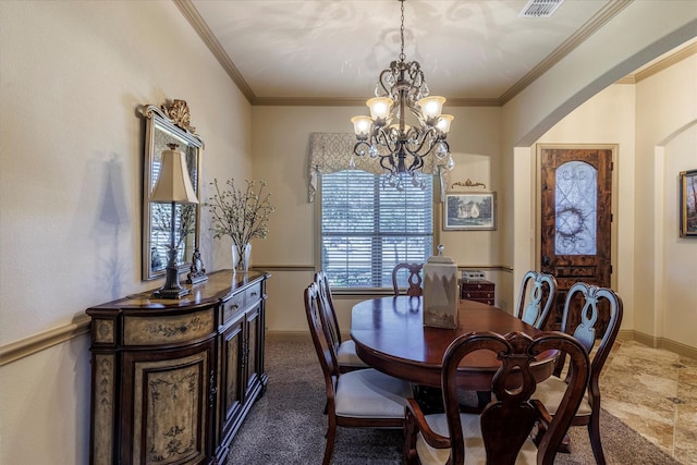 dining area featuring visible vents, arched walkways, baseboards, and ornamental molding