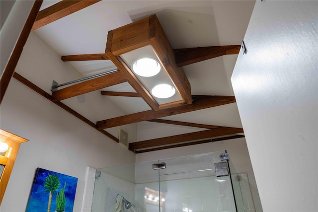 interior details with beamed ceiling, visible vents, and a stall shower