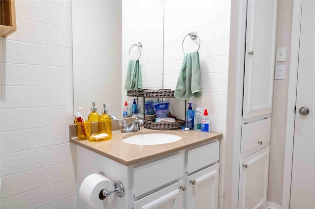 bathroom with vanity and tile walls