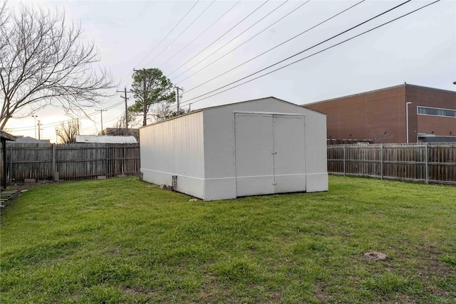 view of shed with a fenced backyard