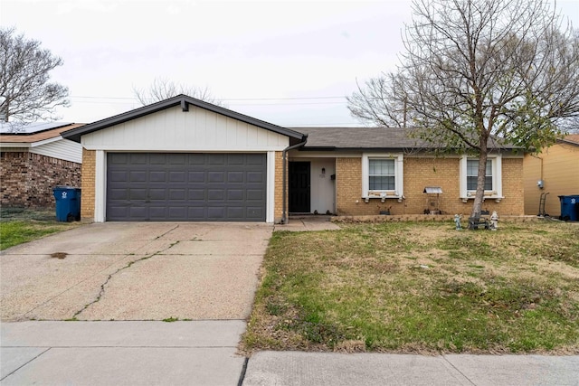 ranch-style home with driveway, a front yard, a shingled roof, a garage, and brick siding