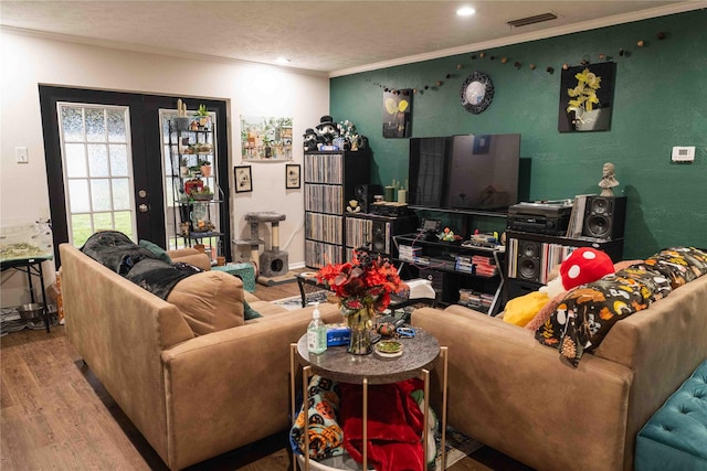 living area featuring visible vents, ornamental molding, recessed lighting, french doors, and wood finished floors