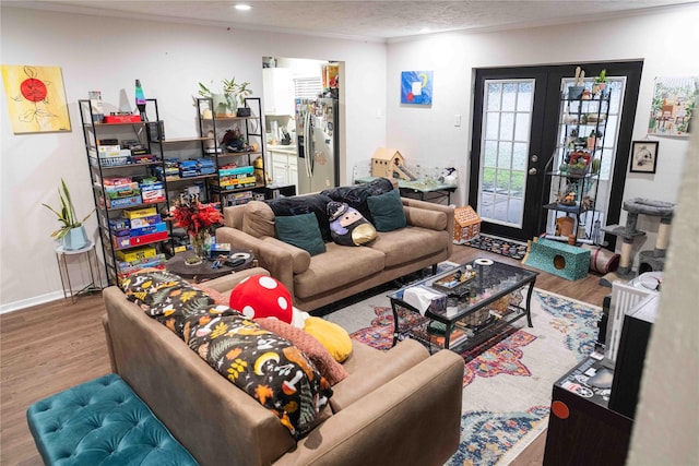 living room with baseboards, recessed lighting, french doors, wood finished floors, and a textured ceiling