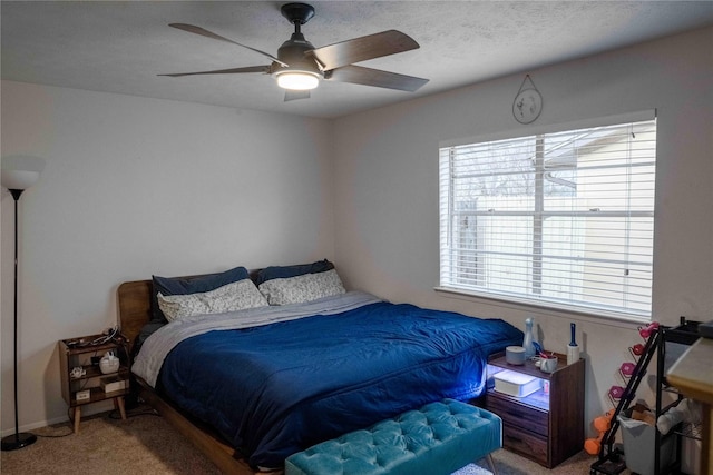 bedroom with a textured ceiling, ceiling fan, and carpet flooring