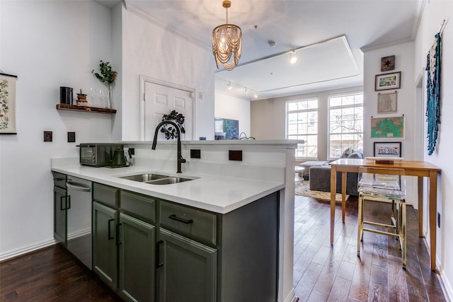 kitchen with dishwasher, dark wood-style floors, a peninsula, green cabinets, and a sink