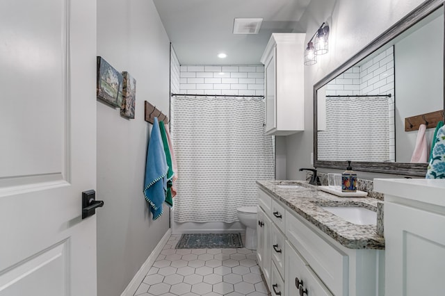 full bathroom featuring double vanity, visible vents, toilet, a sink, and baseboards