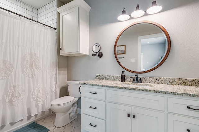 bathroom featuring tile patterned flooring, vanity, and toilet