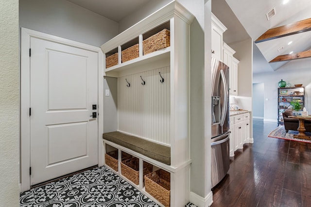 mudroom with lofted ceiling, dark wood-style flooring, visible vents, and baseboards