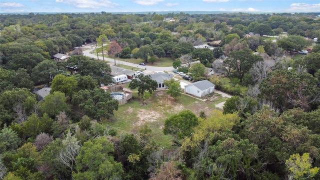 birds eye view of property with a wooded view