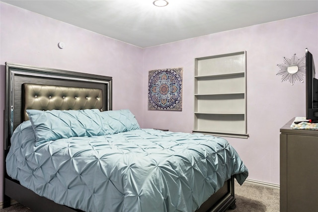 carpeted bedroom featuring baseboards