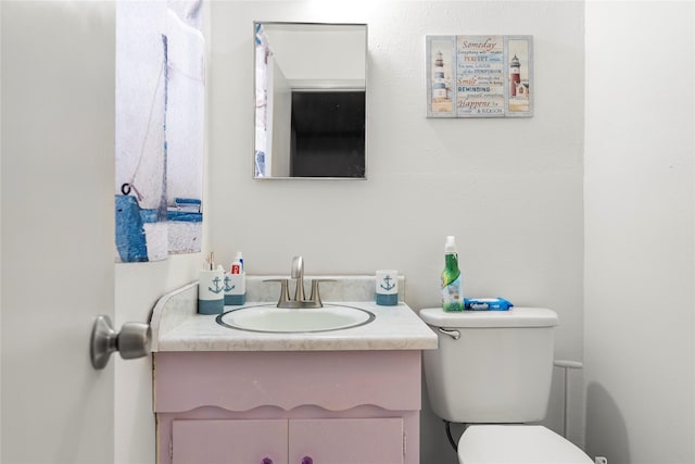 bathroom featuring toilet and vanity