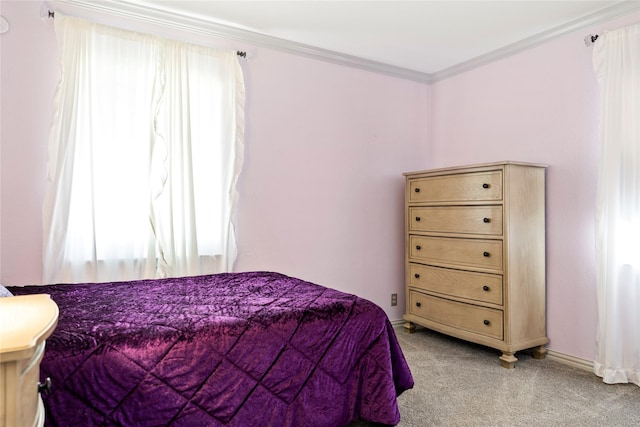 bedroom with light colored carpet, crown molding, and baseboards