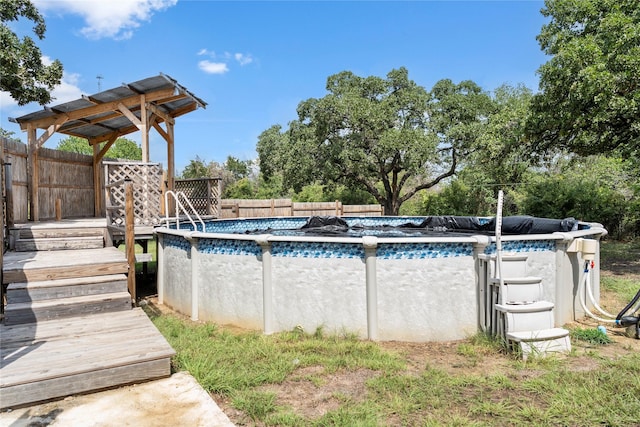 outdoor pool featuring a deck and fence