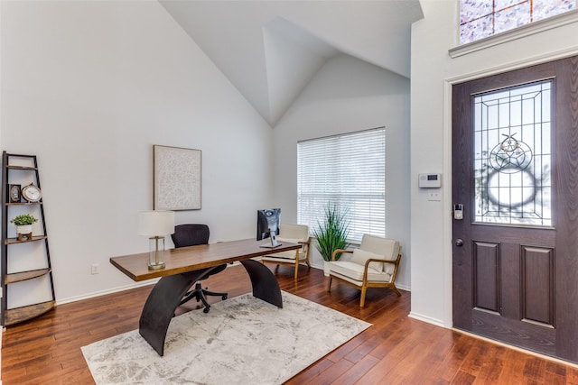 office space with high vaulted ceiling, wood-type flooring, and baseboards