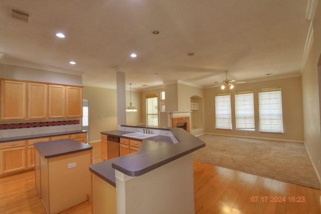 kitchen featuring a center island with sink, visible vents, dark countertops, a sink, and stainless steel dishwasher