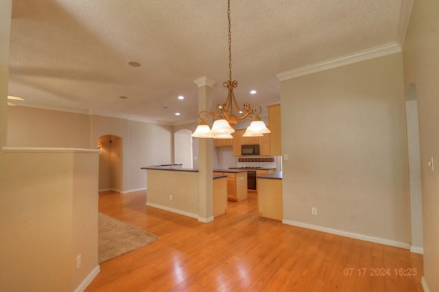 kitchen with light wood-type flooring, black microwave, arched walkways, and open floor plan