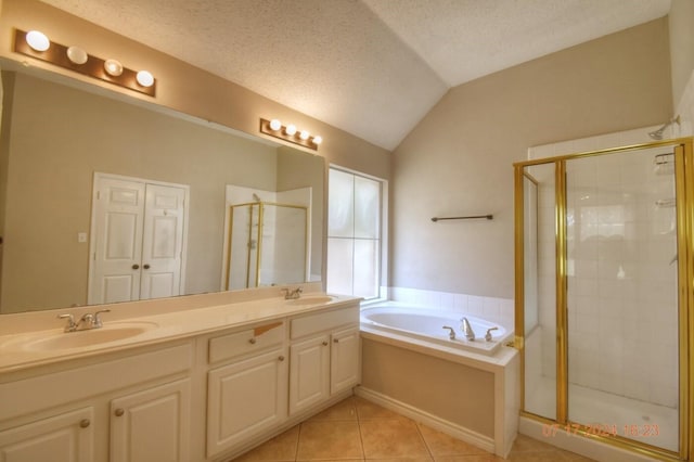 full bathroom featuring a stall shower, a garden tub, a sink, and tile patterned floors