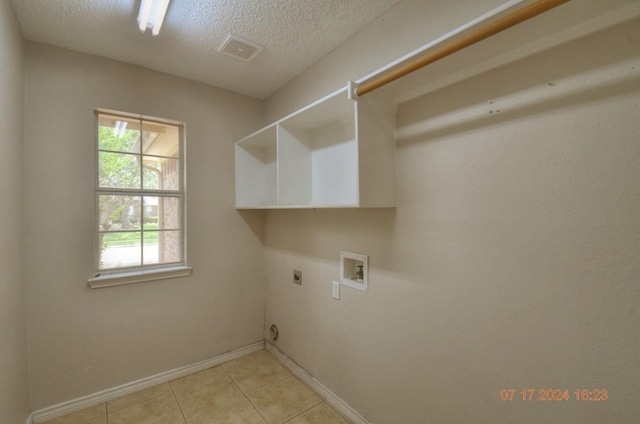 laundry area with laundry area, washer hookup, visible vents, a healthy amount of sunlight, and electric dryer hookup