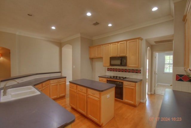 kitchen with arched walkways, dark countertops, light wood-style flooring, a sink, and black appliances