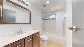 full bath featuring shower / bathtub combination, visible vents, vanity, and toilet