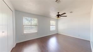 empty room featuring baseboards and wood finished floors