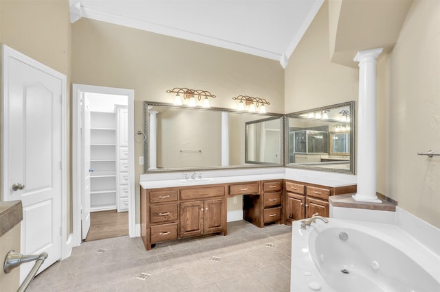 full bathroom with a tub with jets, ornamental molding, vanity, and ornate columns
