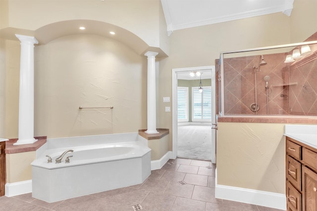 bathroom featuring tiled shower, ornamental molding, a garden tub, vanity, and ornate columns