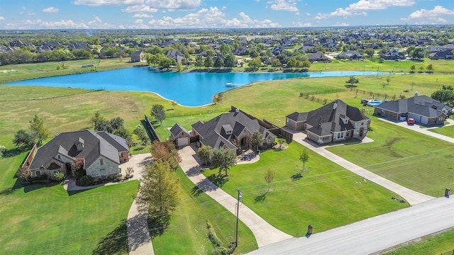 drone / aerial view with a water view and a residential view