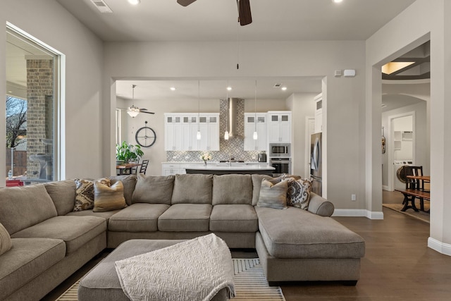 living area featuring dark wood-style floors, recessed lighting, ceiling fan, and baseboards