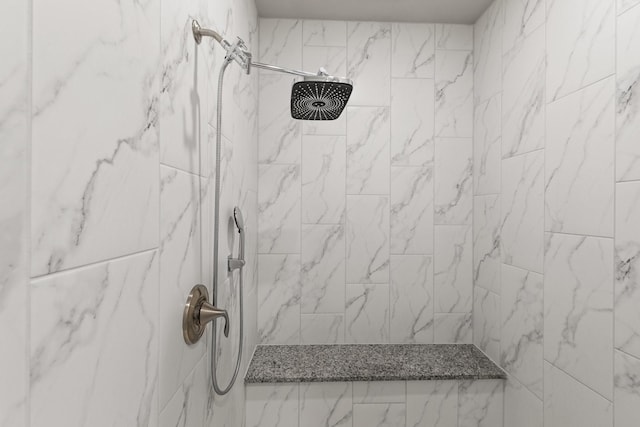 bathroom with tiled shower