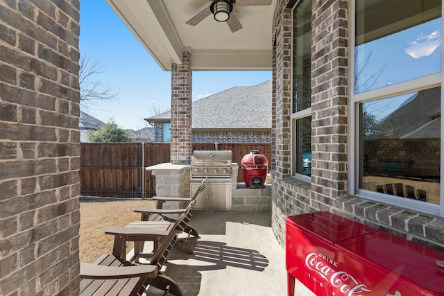 view of patio / terrace with a fenced backyard, a ceiling fan, and area for grilling