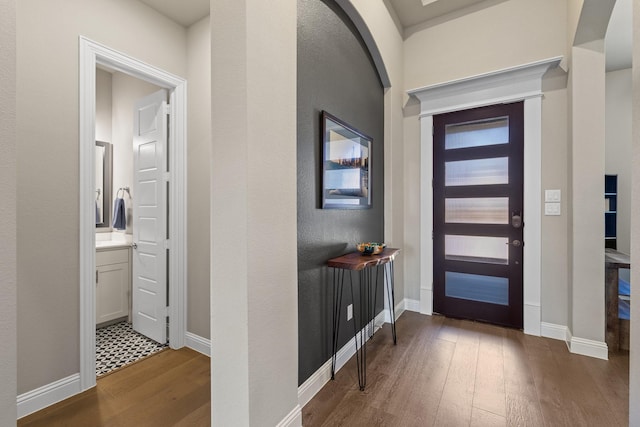 entryway featuring hardwood / wood-style flooring and baseboards