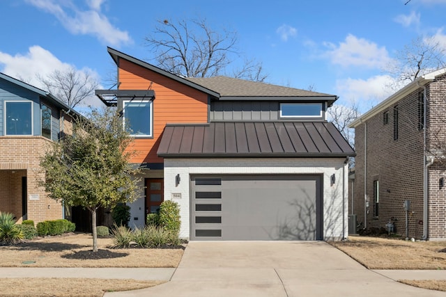 view of front of house featuring brick siding, a shingled roof, concrete driveway, a standing seam roof, and a garage