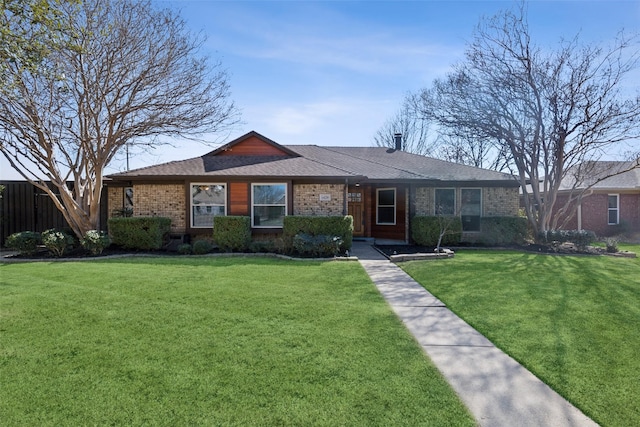 single story home with brick siding, a front lawn, and roof with shingles