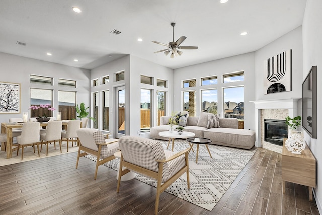 living room with plenty of natural light, dark wood-style floors, and visible vents