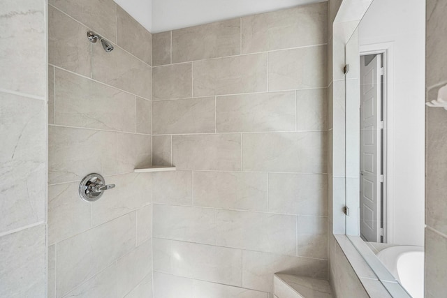 full bath with a tile shower