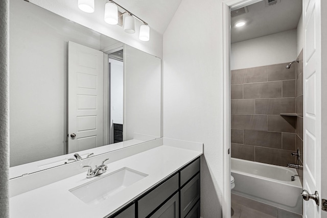 bathroom featuring vanity, visible vents, bathtub / shower combination, tile patterned floors, and toilet