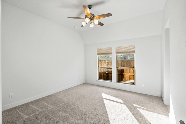 spare room with baseboards, lofted ceiling, a ceiling fan, and carpet flooring