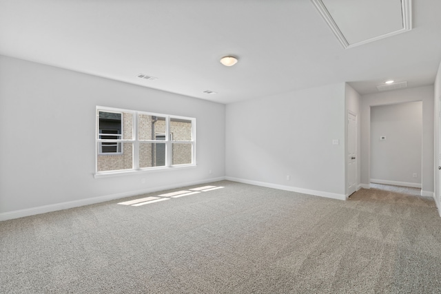 unfurnished room featuring attic access, recessed lighting, carpet flooring, and baseboards