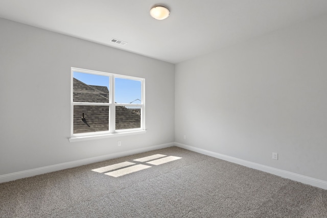 carpeted empty room with baseboards and visible vents